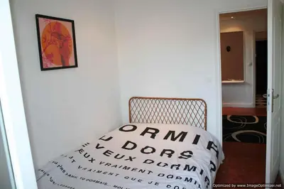 a white chair with a pillow sitting in a room at Beach, Pure Centre, view over Opera de Nice in Nice