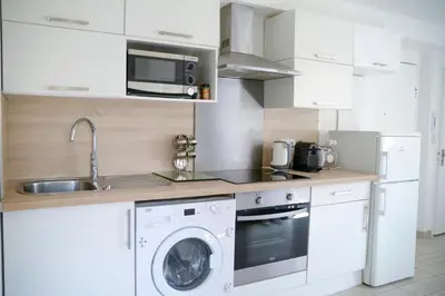 a kitchen with a washing machine and a sink at Sunny apartment in heart of Nice Old Town in Nice
