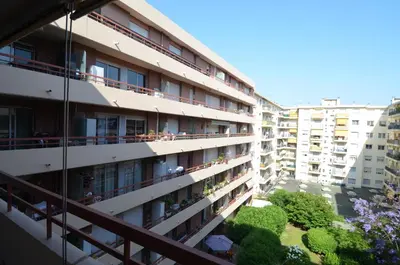 an apartment building with people on the balconies at SIENA - Appartement 6 personnes avec Terrasse et Jacuzzi plein cœur centre-ville quartier du Port de Nice in Nice