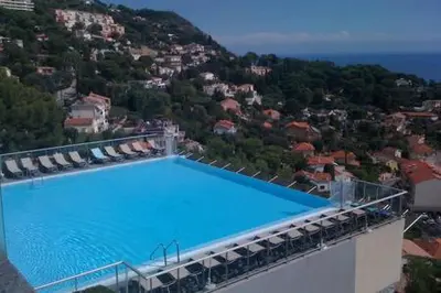 an overhead view of a large blue swimming pool at Appt 5 personnes vue mer piscine Costa Plana Cap d'Ail Monaco in Cap d'Ail