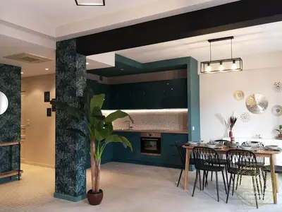 a dining room and kitchen with a table and chairs at Appartement Carré d'Or Vue sur Mer in Nice