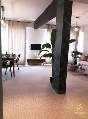 a living room with a couch and a table at Appartement Carré d'Or Vue sur Mer in Nice
