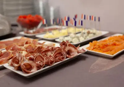 a table with several plates of food on a table at Hôtel restaurant Oasis in Nice