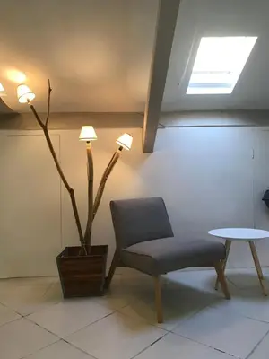 a chair and a table in a room at Les Citronniers in Villefranche-sur-Mer