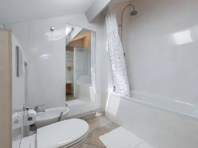 a white bathroom with a toilet and a sink at Les Citronniers in Villefranche-sur-Mer