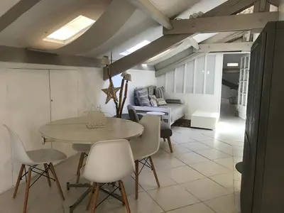 a living room with a table and chairs and a couch at Les Citronniers in Villefranche-sur-Mer