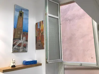 a window in a room with paintings on the wall at Nissa la Bella in Nice