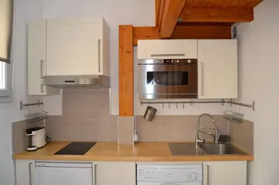a kitchen with a sink and a microwave at Aoustin in Nice