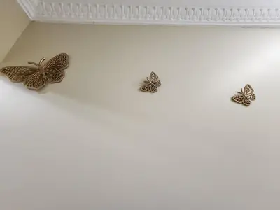 three butterflies on the wall of a room at Promenade Appartements les Lions in Nice
