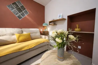 a living room with a couch and a vase of flowers at Promenade Appartements les Lions in Nice