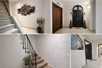 a staircase in a house with a black door at Promenade Appartements les Lions in Nice