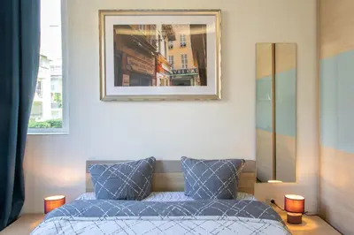 a bedroom with a bed and a picture on the wall at Boutique apartment LA LAVANDE free parking CENTER Nice in Nice