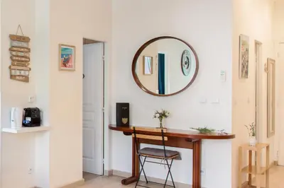 a hallway with a desk and a mirror on the wall at Boutique apartment LA LAVANDE free parking CENTER Nice in Nice
