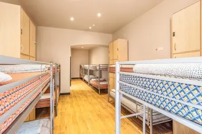a room filled with lots of bunk beds at Villa Saint Exupery Beach Hostel in Nice