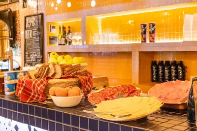 a counter with eggs and bread and other food on it at Villa Saint Exupery Beach Hostel in Nice