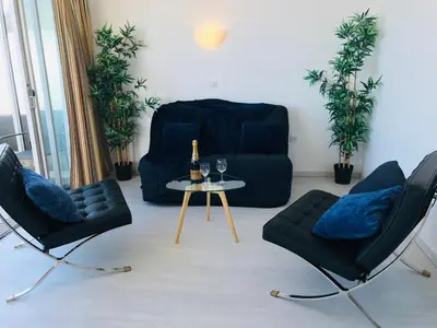a balcony with a table and chairs and the ocean at COSTA PLANA COLLECTION - Cap d'Ail - Monaco in Cap d'Ail