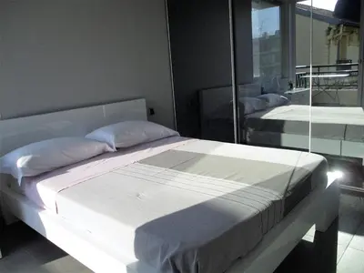 a bedroom with two beds and a mirror at Appartement Cattleya - rue halevy in Nice