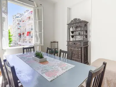 a dining room with a table and chairs and a window at Apartment Hérold-1 by Interhome in Nice