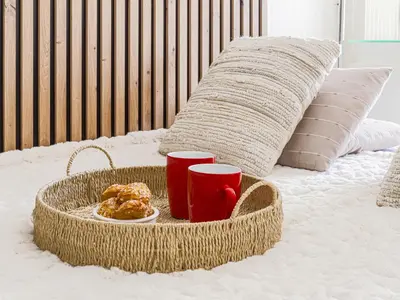 a tray of food and two red cups on a bed at Studio Ciel de Fabron by Interhome in Nice