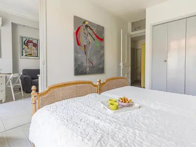 a white bed with a tray of fruit on it at Apartment Le Concordia by Interhome in Nice