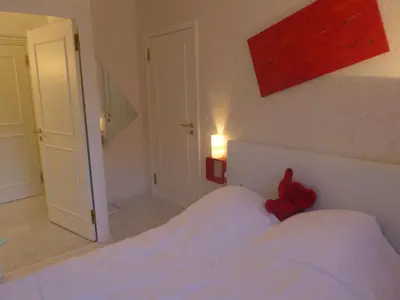 a bedroom with a bed with a red teddy bear on it at Apartment Les Balcons d'Eze-1 by Interhome in Èze