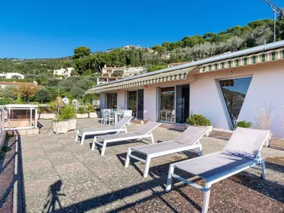a row of chaise lounge chairs on a patio at Apartment Les Balcons d'Eze-1 by Interhome in Èze