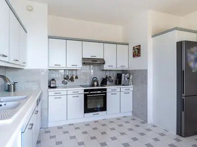 a white kitchen with white cabinets and a sink at Apartment Les Balcons d'Eze-1 by Interhome in Èze