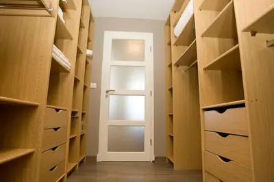a walk in closet with a door and wooden shelves at Le Rooftop 180 in Villefranche-sur-Mer