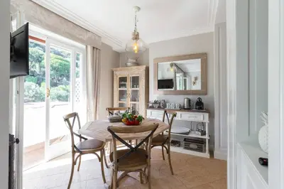 a kitchen and dining room with a table and chairs at Le Corot in Beaulieu-sur-Mer