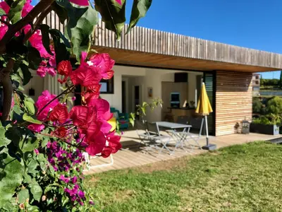 a house with pink flowers in the yard at La Coulina in Nice
