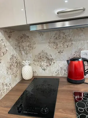 a kitchen with a red kettle on a counter at Studio With Swimming Pool 80 meters near the beach in Nice