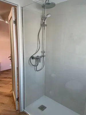 a shower with a shower head in a bathroom at Studio With Swimming Pool 80 meters near the beach in Nice