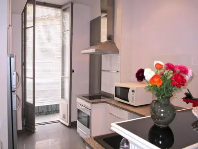 a kitchen with a vase of flowers on a counter at Appartement in Nice