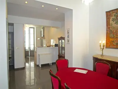 a dining room with a red table and chairs at Appartement in Nice