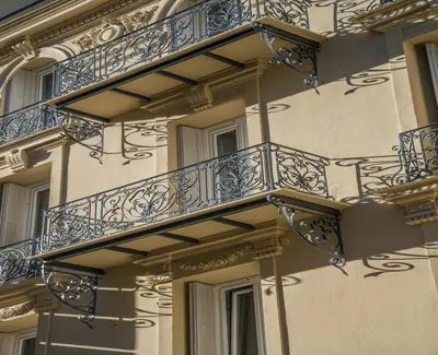 a building with blue balconies on the side of it at Hotel Paganini in Nice