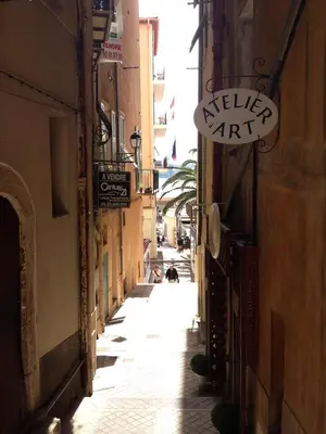 an alley in an old town with buildings at Seagulls in Villefranche-sur-Mer