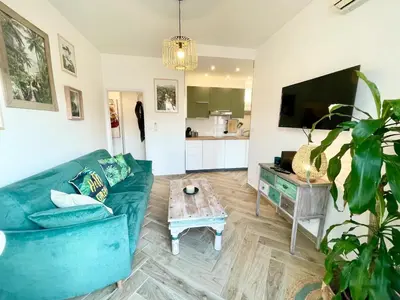 a living room with a blue couch and a coffee table at Homelivia Av Jean Médecin in Nice