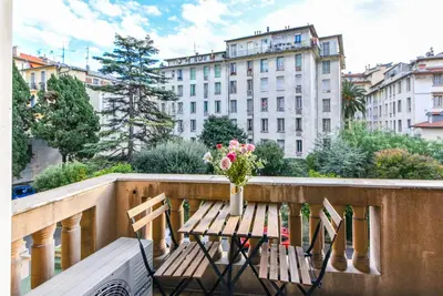 a table with a vase of flowers on a balcony at Le Maréchal in Nice