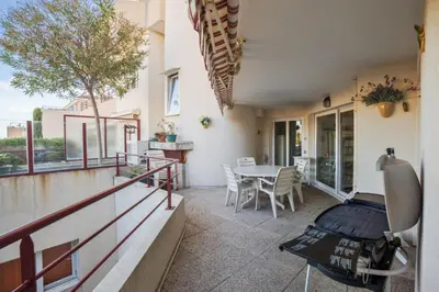 a balcony of a house with a table and chairs at Appartement Lanterne Welkeys in Nice