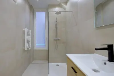 a bathroom with a glass shower and a sink at Maison Bianchi - Raspail in Nice