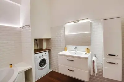 a white bathroom with a sink and a washing machine at Nice Plein Centre, Calme et Proche de la mer in Nice