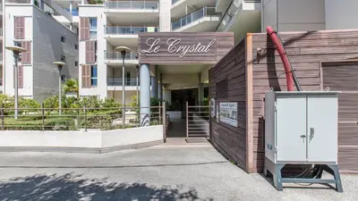 a building with a sign in front of it at Vacancéole - Résidence Le Crystal in Cagnes-sur-Mer