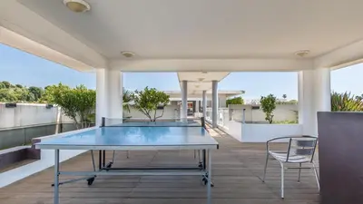a table on the balcony of a house at Vacancéole - Résidence Le Crystal in Cagnes-sur-Mer