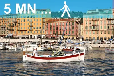 a boat in the water in a harbor with buildings at BARILLERIE - Loft Moderne, Face Mer, Vieux-Nice. in Nice
