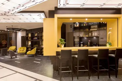 a bar in a restaurant with chairs and tables at Best Western Hôtel Journel Saint-Laurent-du-Var Aéroport in Saint-Laurent-du-Var