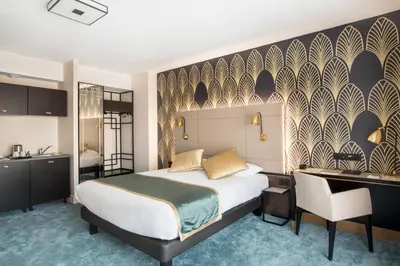 a bedroom with a bed and a desk and a kitchen at Best Western Hôtel Journel Saint-Laurent-du-Var Aéroport in Saint-Laurent-du-Var