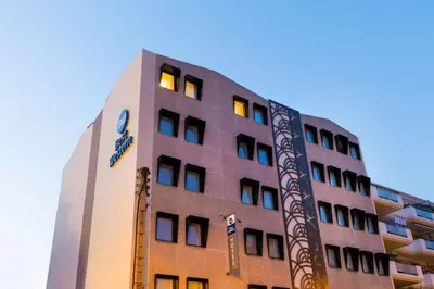 a tall building with lights on top of it at Best Western Hôtel Journel Saint-Laurent-du-Var Aéroport in Saint-Laurent-du-Var
