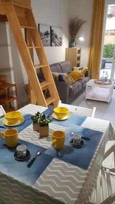 a table with yellow bowls and plates on a blue table cloth at Nice France in Nice