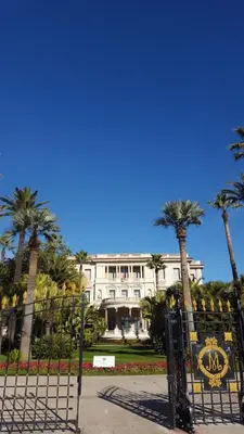 a large white building with palm trees in front of it at Nice France in Nice