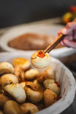 a person holding a spoonful of food in a bowl at Hotel De La Darse in Villefranche-sur-Mer